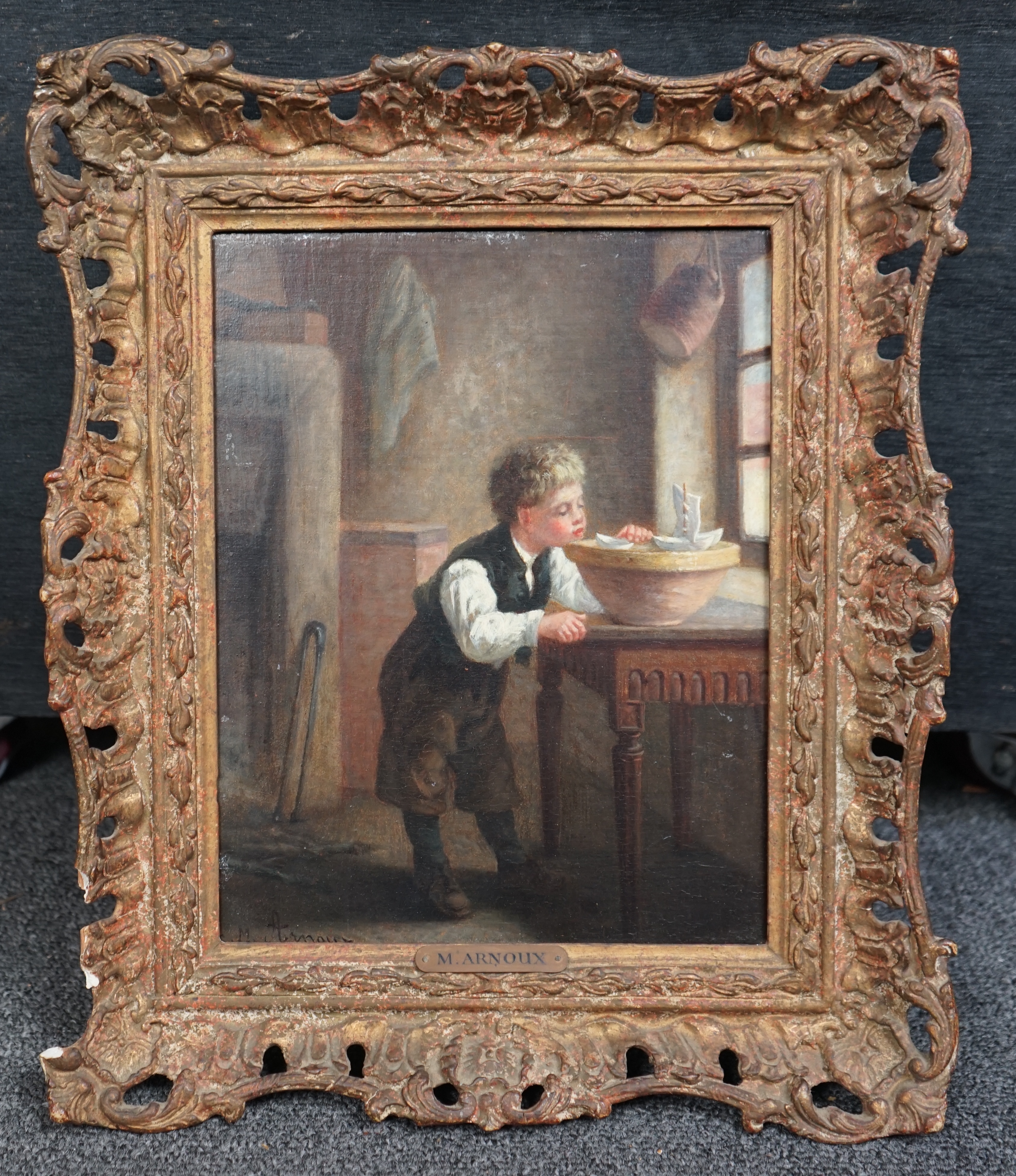Michel Arnoux (French, 1833-1877), oil on mahogany panel, Interior with boy playing with model sailing boats, signed, 24 x 18cm. Condition - fair to good